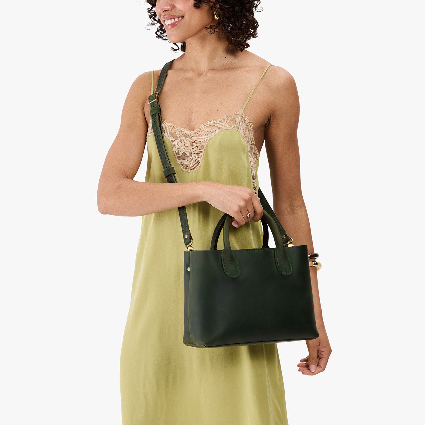 Evergreen*Large | Model wearing a mid-size tote purse with structured leather handles and crossbody strap