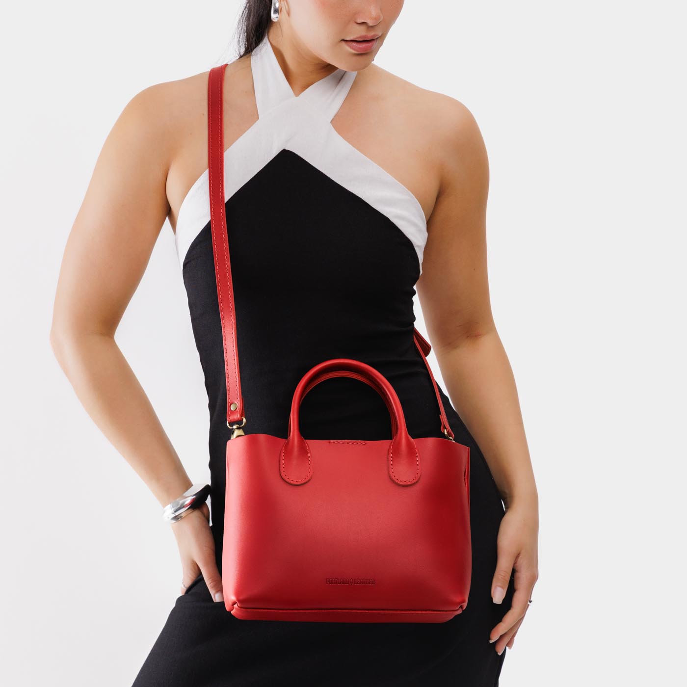 Ruby*Large | Model wearing mid-size tote purse with structured leather handles and crossbody strap