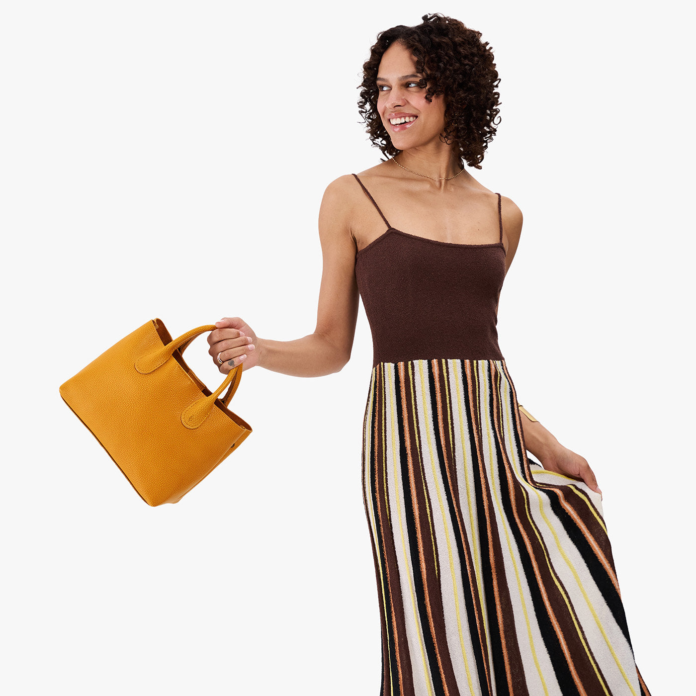 Sunshine*Large | Model wearing a mid-size tote purse with structured leather handles and crossbody strap