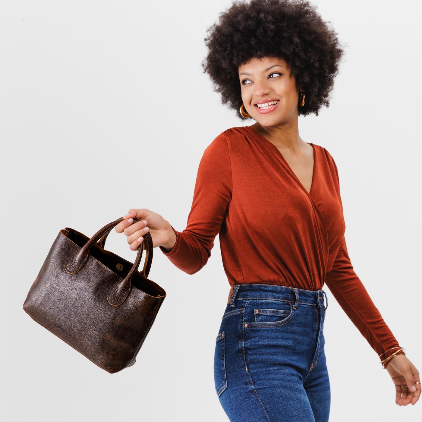 Coldbrew*Large | Model holding mid-size tote purse with structured leather handles and crossbody strap