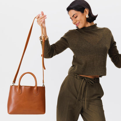 Honey*Large | Model holding mid-size tote purse with structured leather handles and crossbody strap