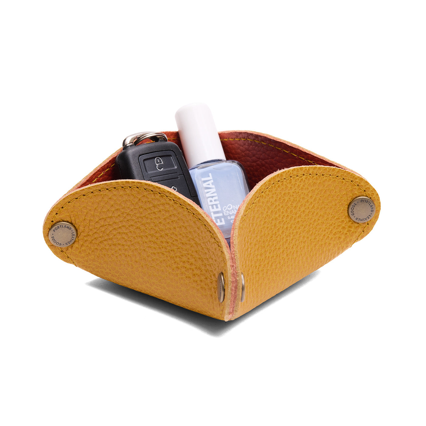 Sunshine | Square-shaped foldable leather tray with snap-button corners holding car keys and nail polish
