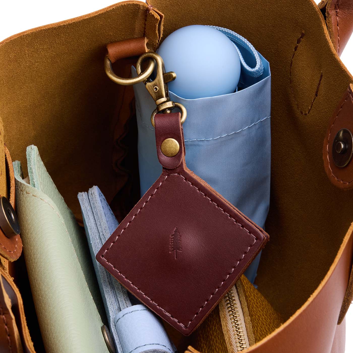 Cognac | Diamond shaped leather AirTag holder on a lobster clasp keychain
