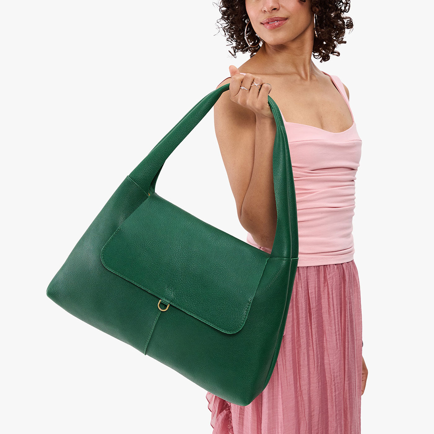Bacalar*Large | A model holding a slouchy triangle shaped shoulder bag with a flap