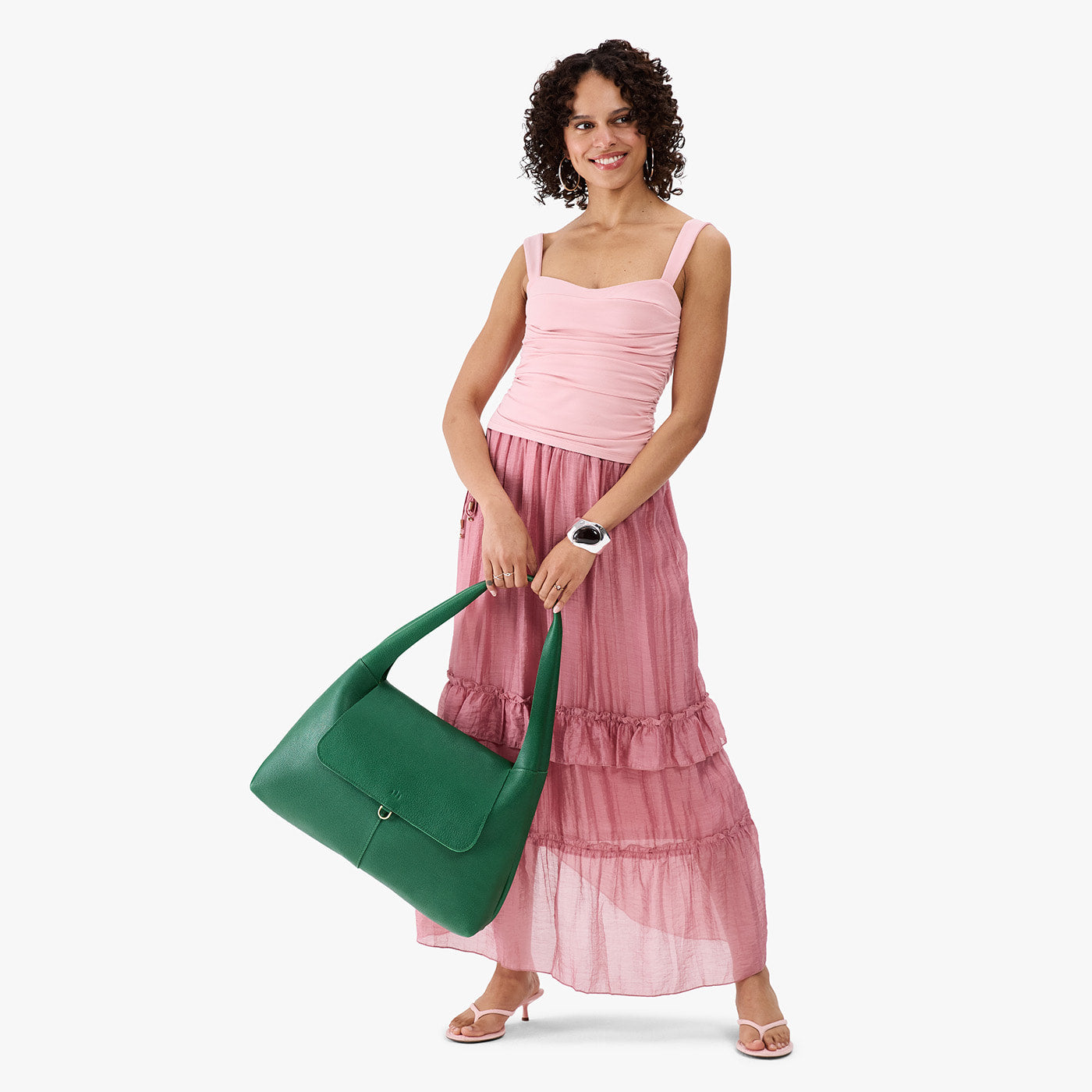 Bacalar*Large | A model holding a slouchy triangle shaped shoulder bag with a flap