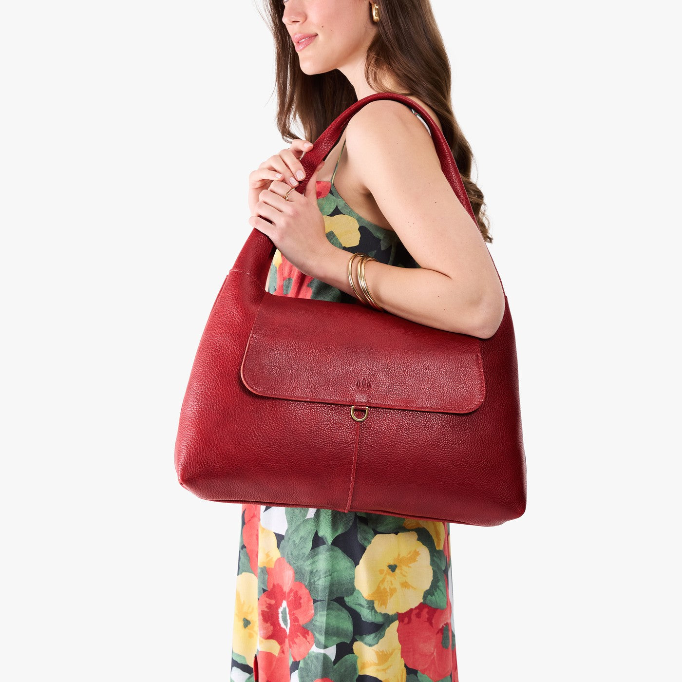 Chili Red*Large | A model holding a slouchy triangle shaped shoulder bag with a flap