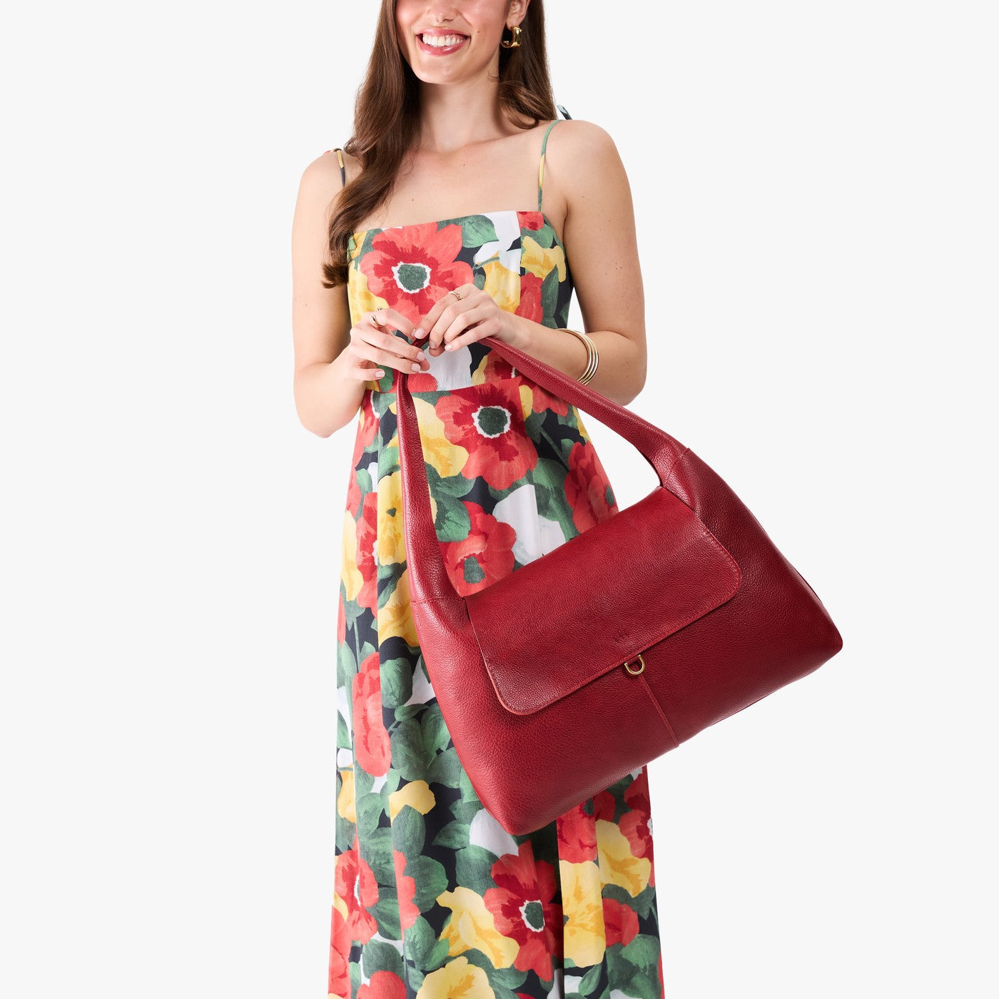 Chili Red*Large | A model holding a slouchy triangle shaped shoulder bag with a flap