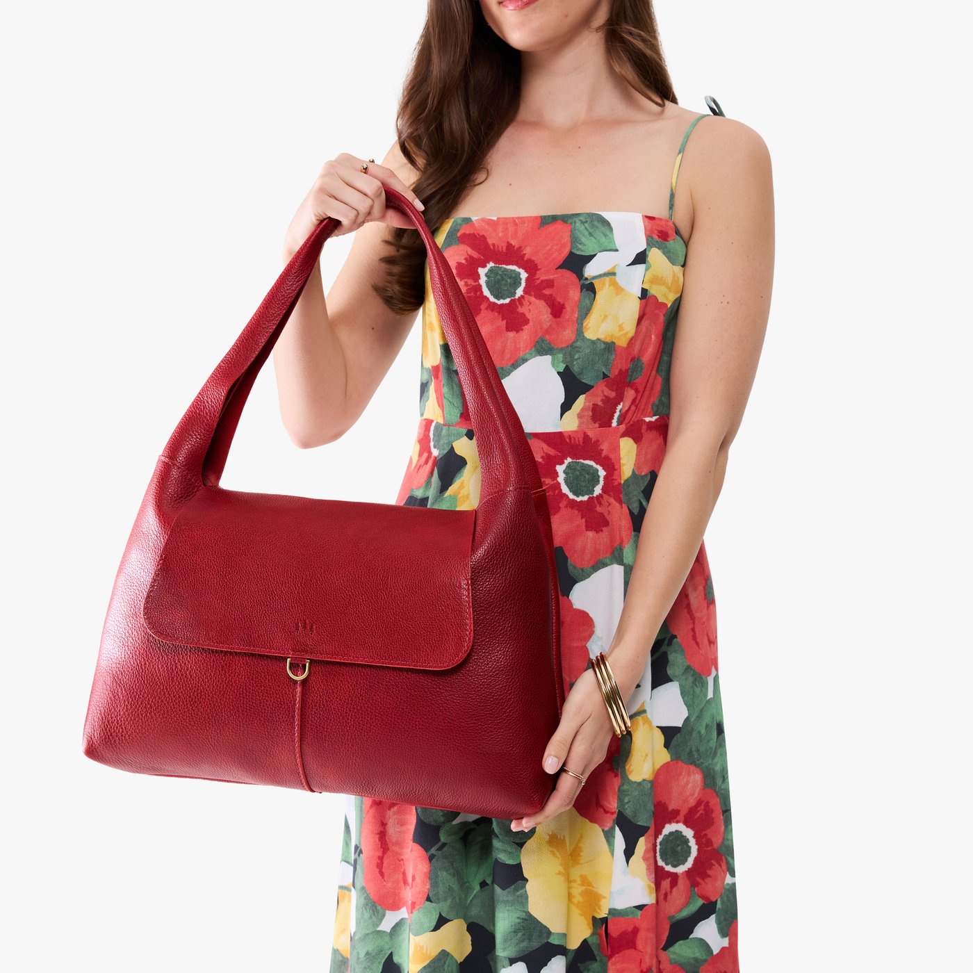 Chili Red*Large | A model holding a slouchy triangle shaped shoulder bag with a flap