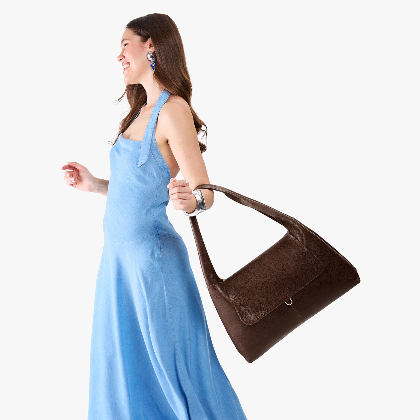 Coldbrew*Large | A model holding a slouchy triangle shaped shoulder bag with a flap