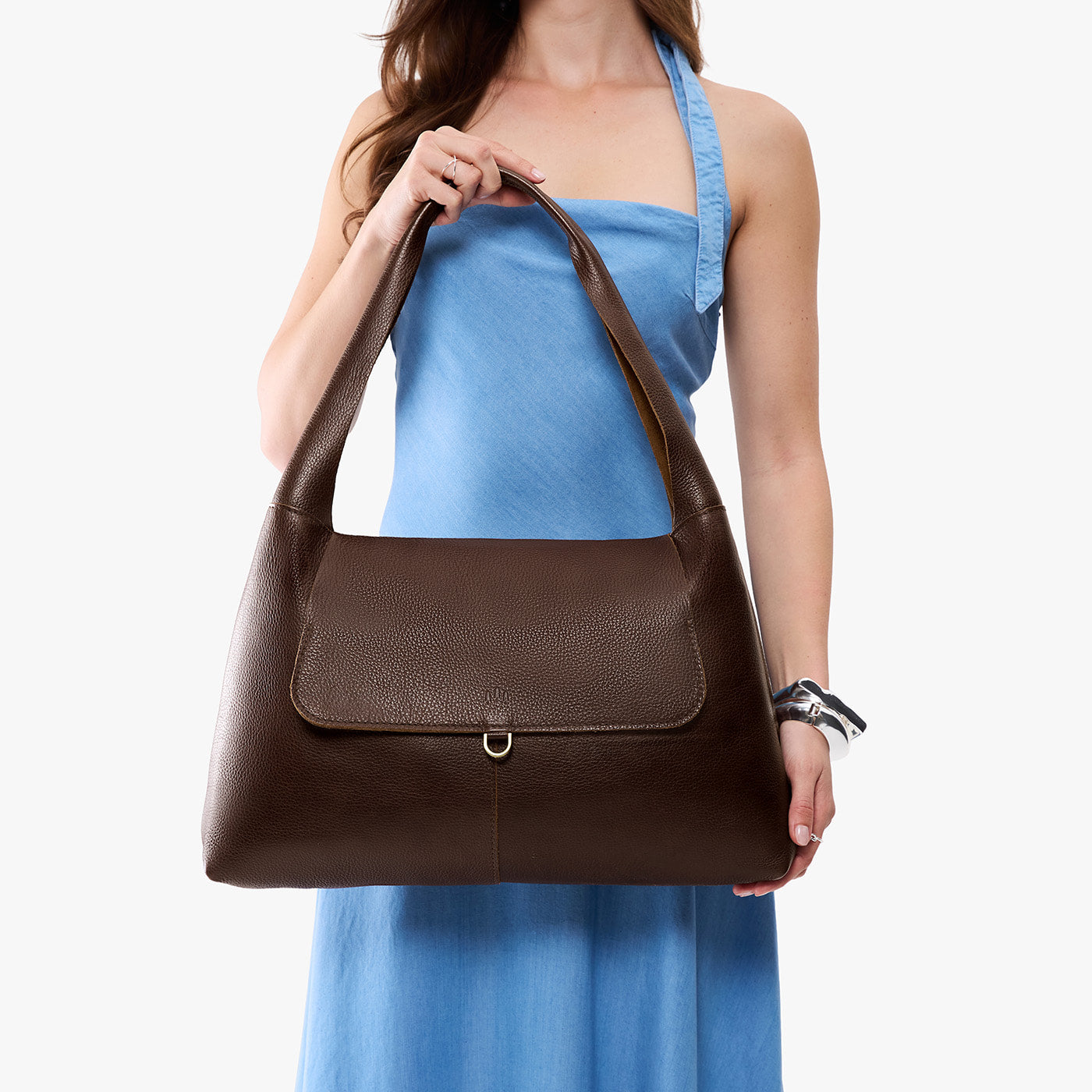 Coldbrew*Large | A model holding a slouchy triangle shaped shoulder bag with a flap