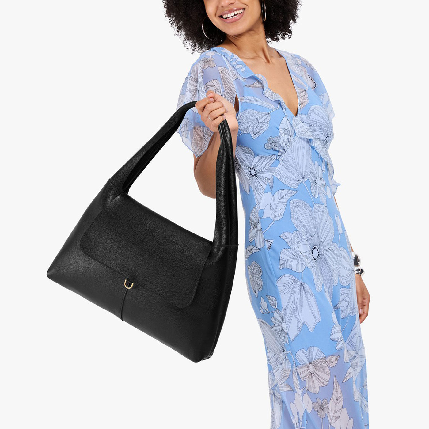 Pebbled--black*Large | A model holding a slouchy triangle shaped shoulder bag with a flap