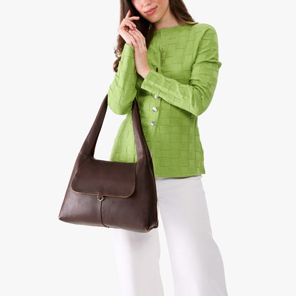 Coldbrew*Medium | A model holding a slouchy triangle shaped shoulder bag with a flap