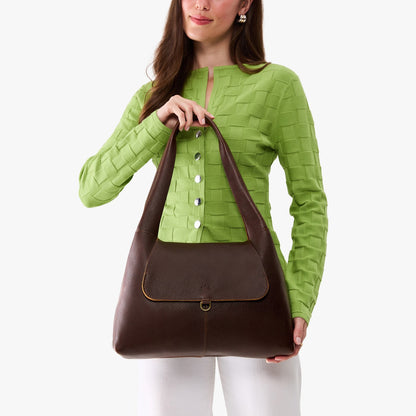 Coldbrew*Medium | A model holding a slouchy triangle shaped shoulder bag with a flap