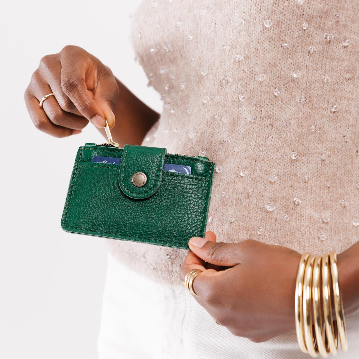 Bacalar | Model holding compact wallet with snap closure and zippered pouch