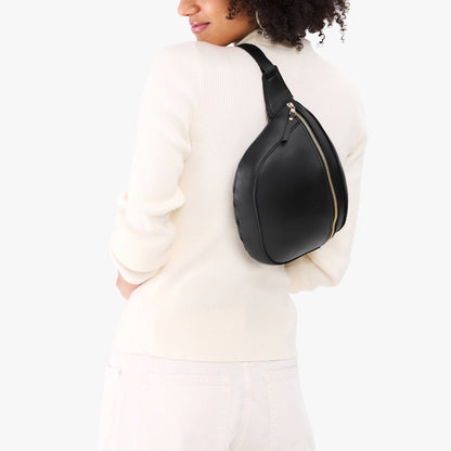 Black | Model wearing a sling bag with front zipper