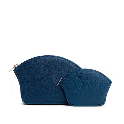 Caspian | Comparison shot of small and large seashell shaped leather makeup bags with curved top zipper and flat bottom