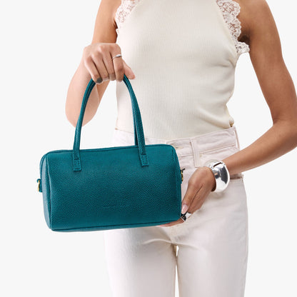 Aquarius*Large | Model holding mini duffle shaped handbag with crossbody strap