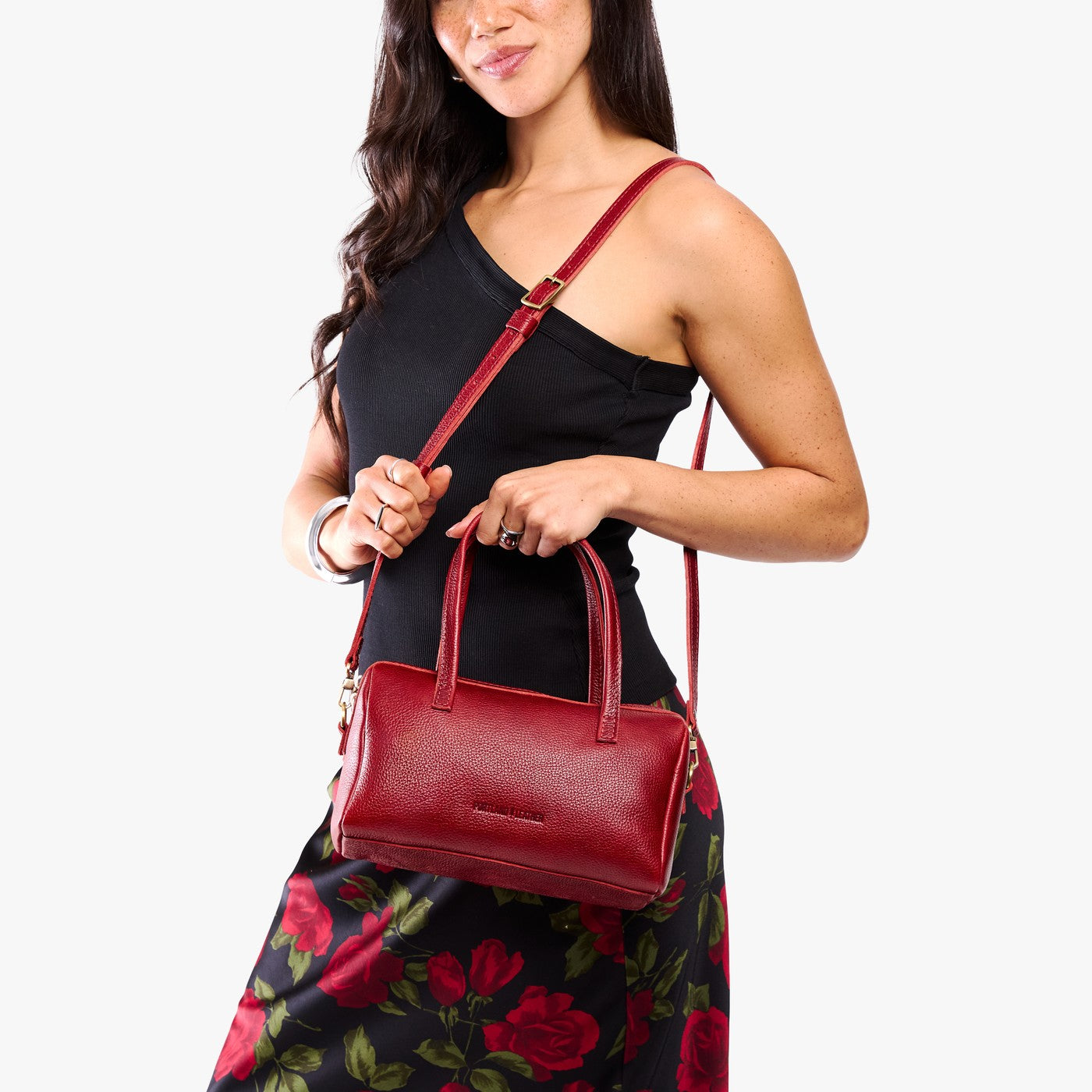 Chili Red*Large | Model holding mini duffle shaped handbag with crossbody strap