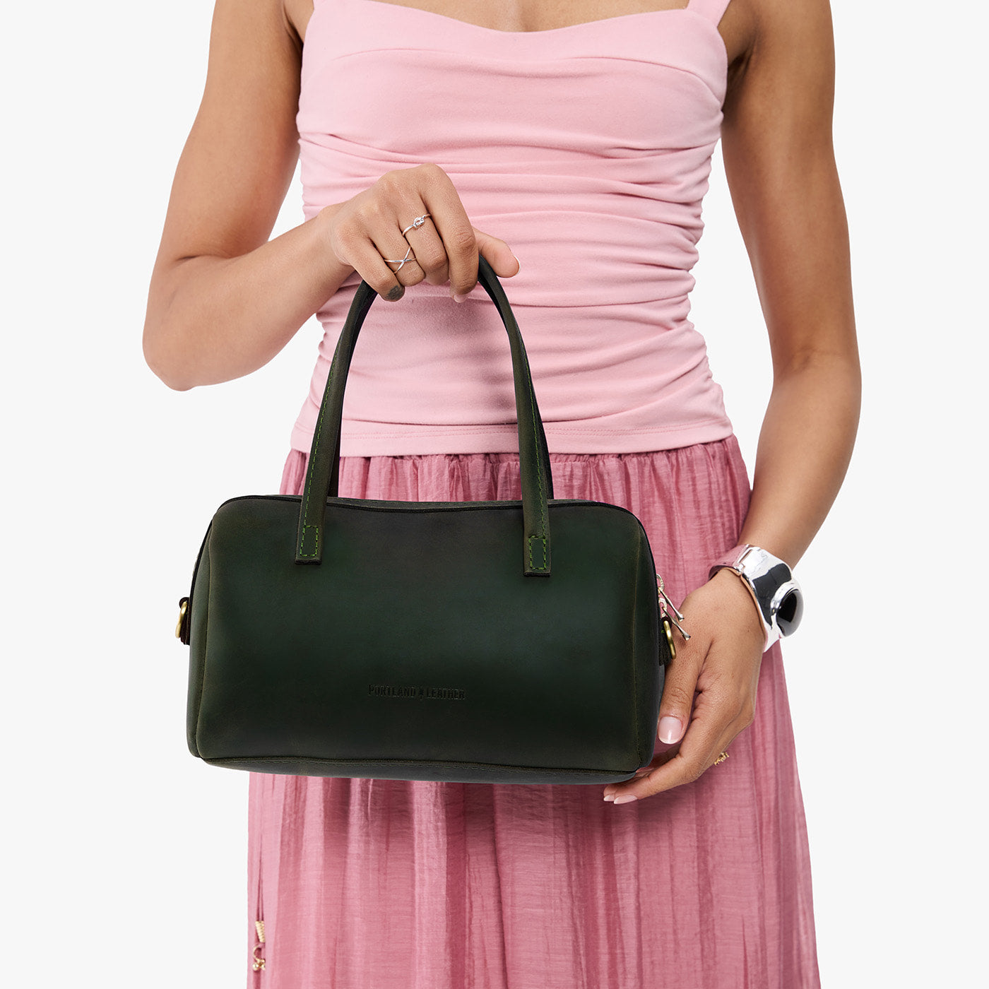 Evergreen*Large | Model holding mini duffle shaped handbag with crossbody strap