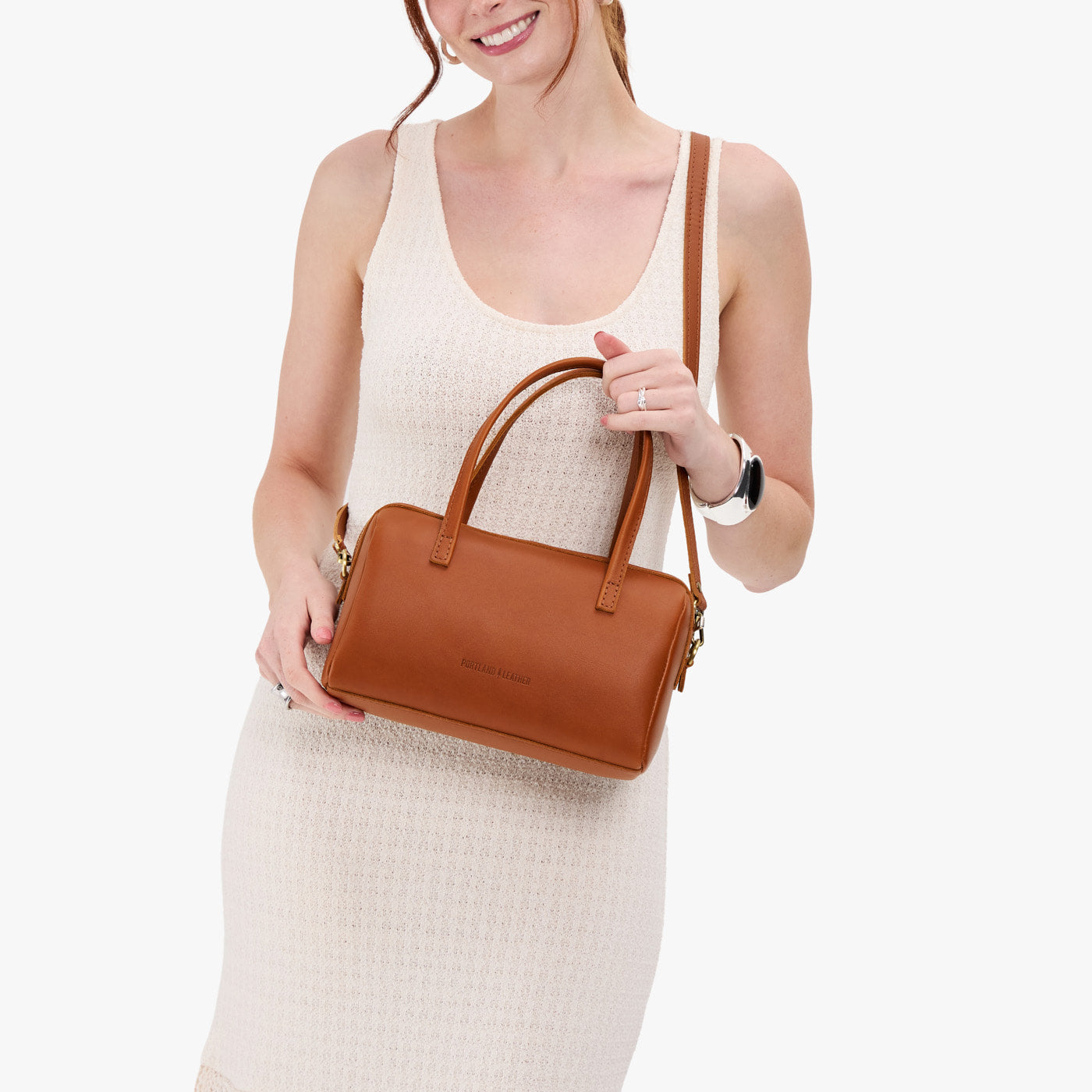 Honey*Large | Model holding mini duffle shaped handbag with crossbody strap