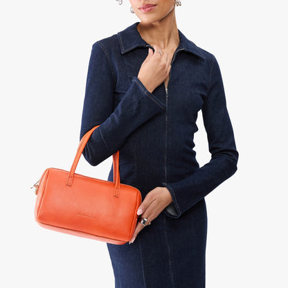 Koi*Large | Model holding mini duffle shaped handbag with crossbody strap
