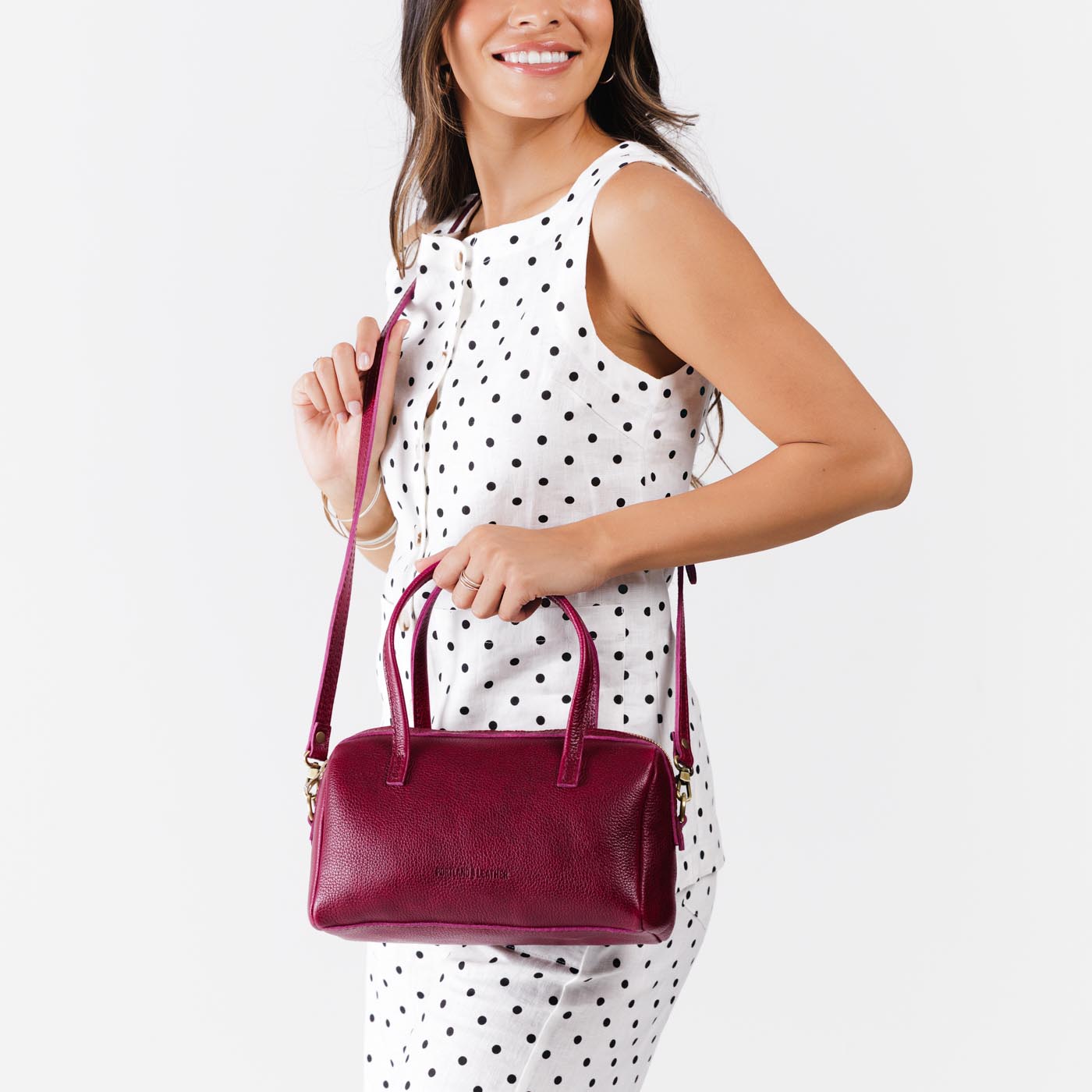 Orchid*Large | Model wearing mini duffle shaped handbag with crossbody strap