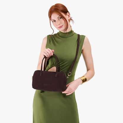 Velvet Brown*Large | Model holding mini duffle shaped handbag with crossbody strap