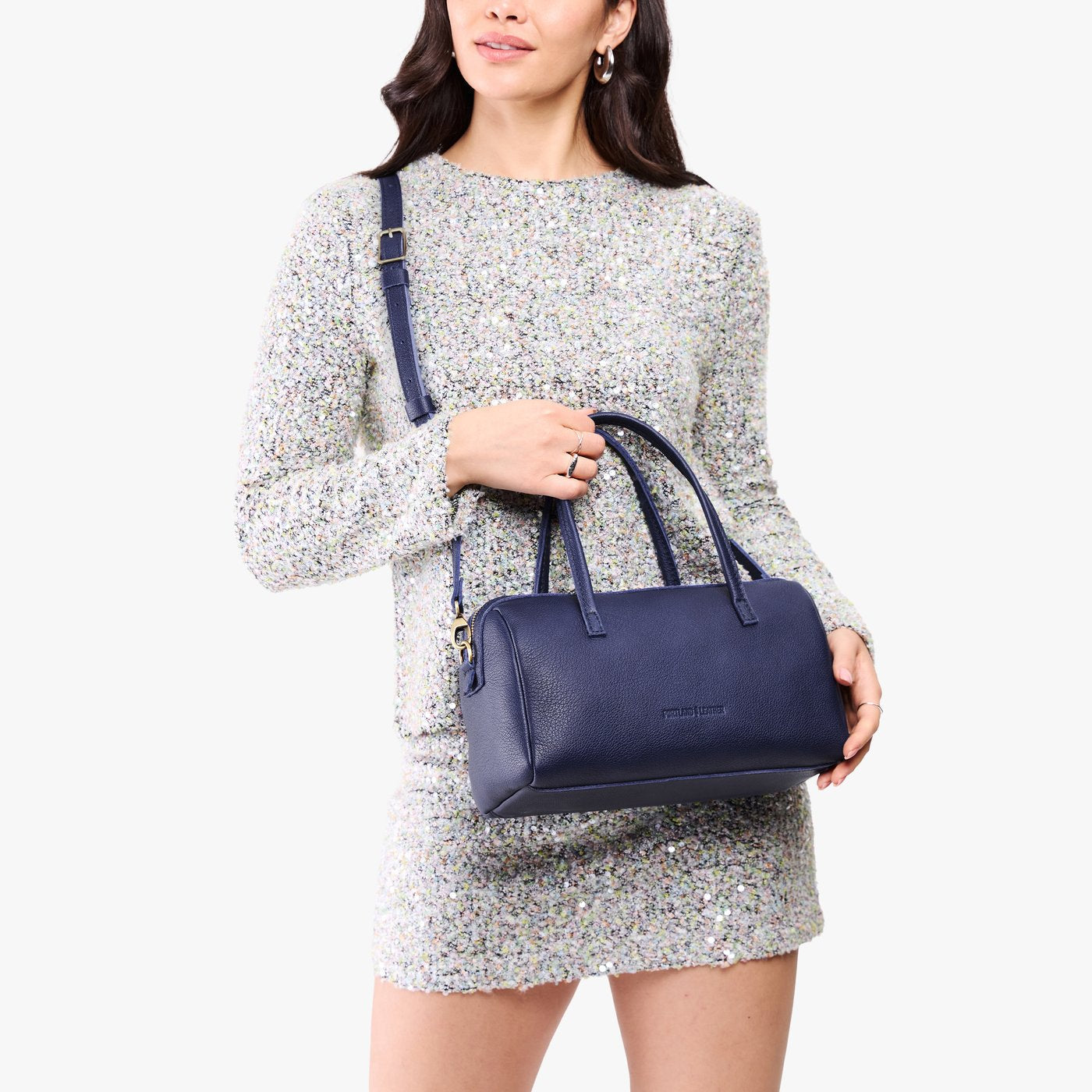 Cobalt*Oversized | Model holding mini duffle shaped handbag with crossbody strap