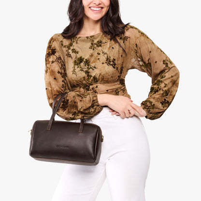 Grizzly*Oversized | Model holding mini duffle shaped handbag with crossbody strap