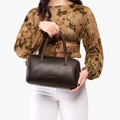 Grizzly*Oversized | Model holding mini duffle shaped handbag with crossbody strap