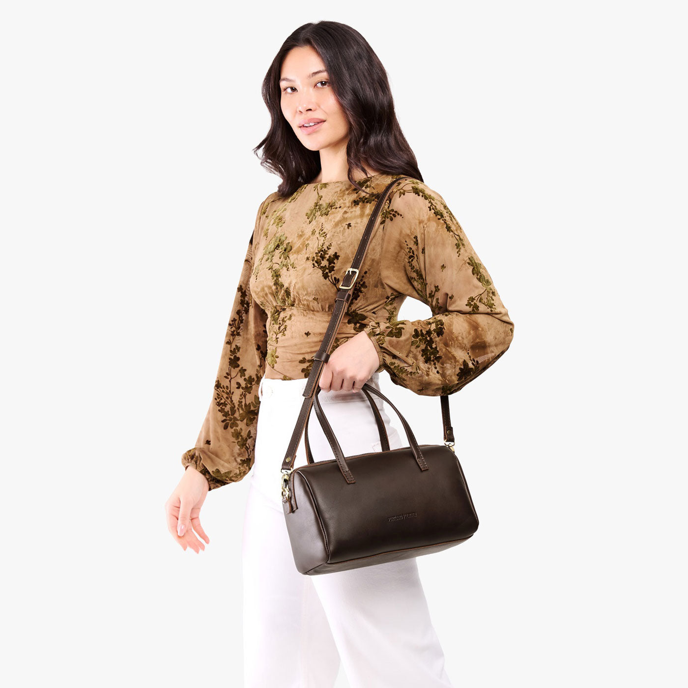 Grizzly*Oversized | Model holding mini duffle shaped handbag with crossbody strap