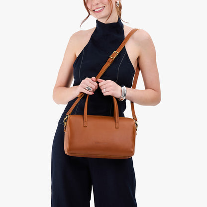 Honey*Oversized | Model holding mini duffle shaped handbag with crossbody strap