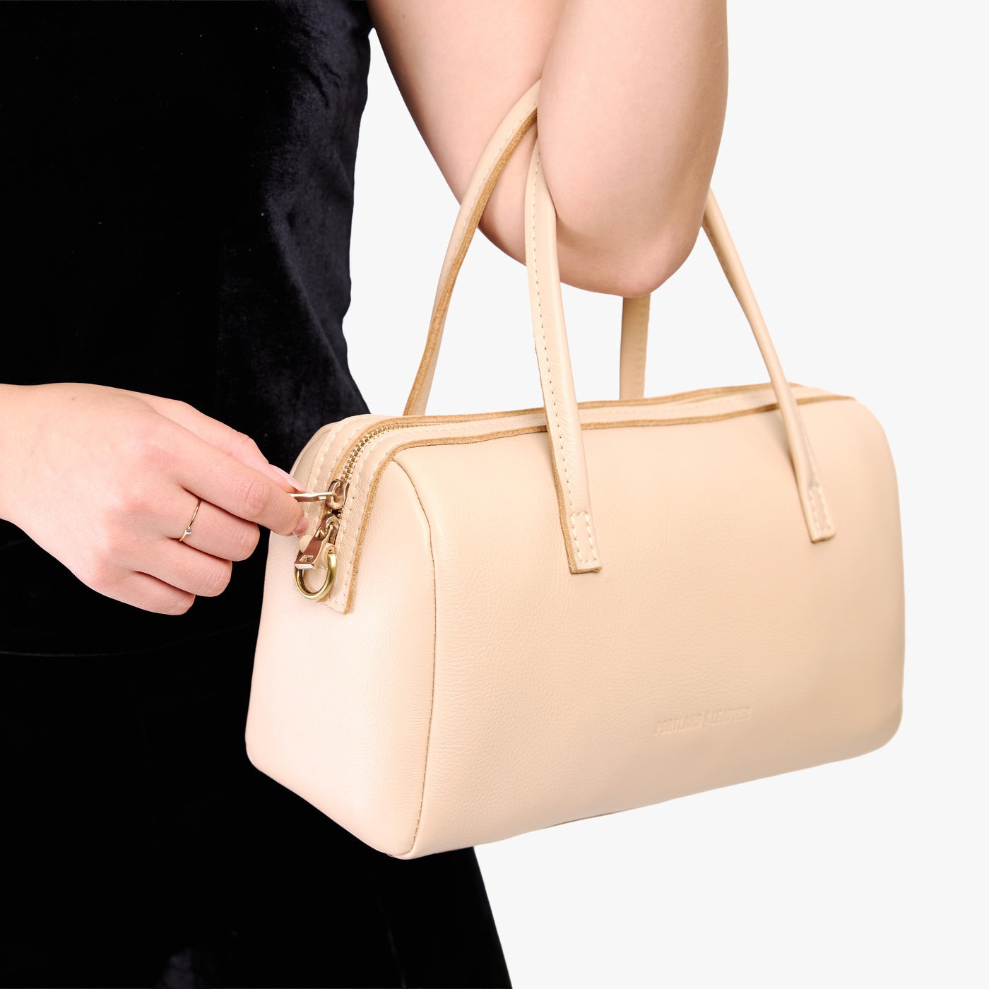 Moonflower*Oversized | Model holding mini duffle shaped handbag with crossbody strap