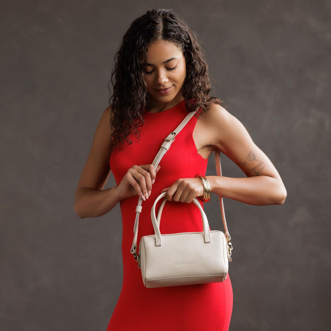 Bone*Small | Model wearing mini duffle shaped handbag with crossbody strap