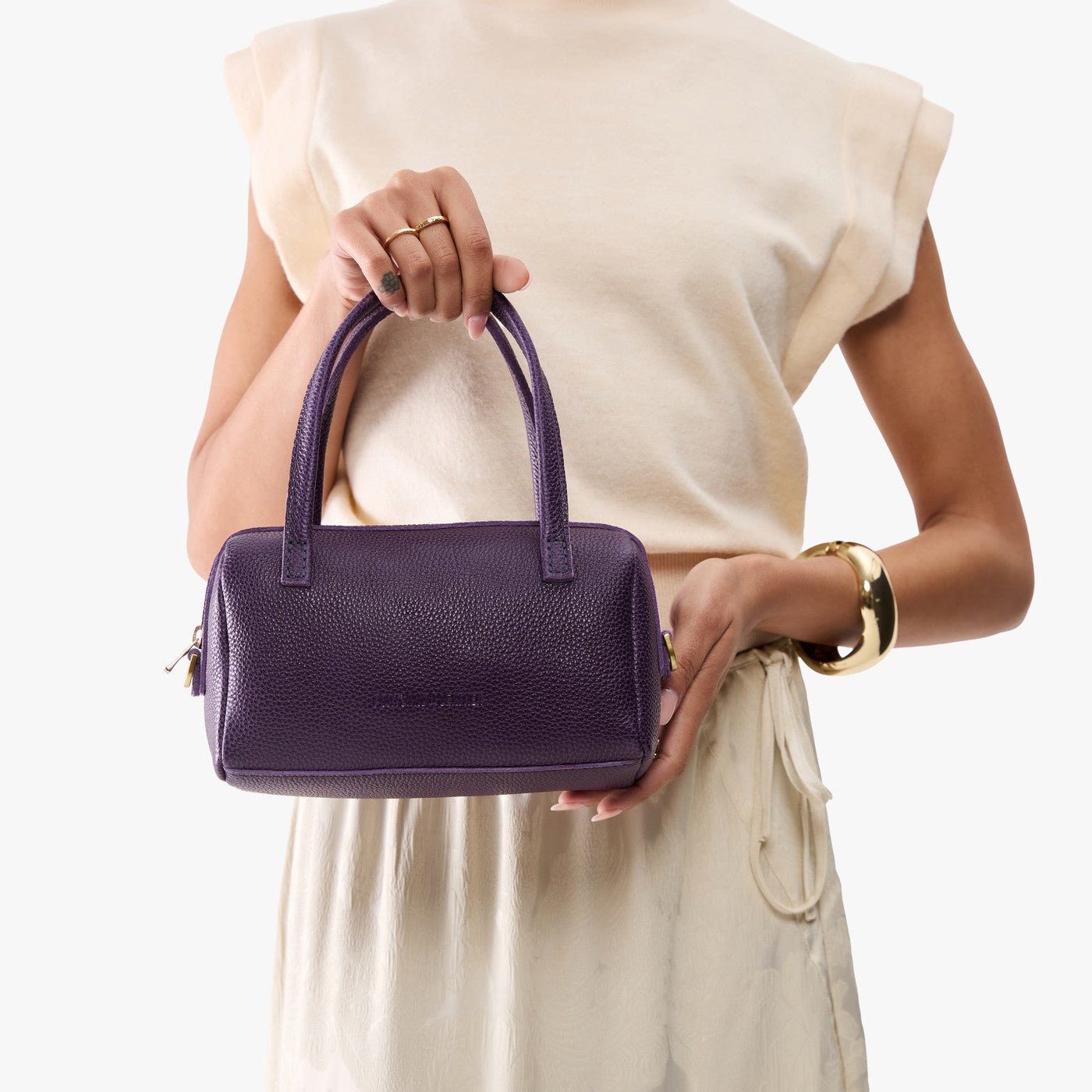 Empire*Small | Model holding mini duffle shaped handbag with crossbody strap