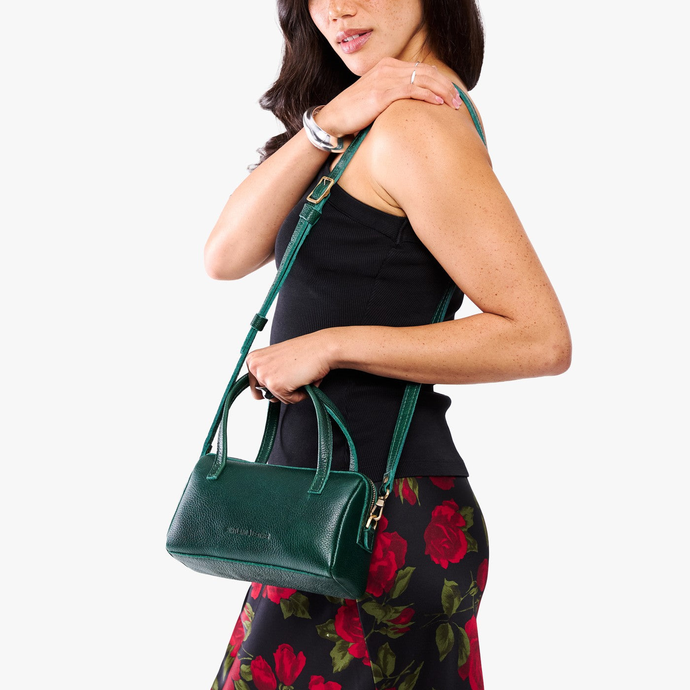 Forest Green*Small | Model holding mini duffle shaped handbag with crossbody strap
