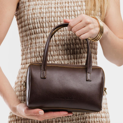 Grizzly*Small | Model wearing mini duffle shaped handbag with crossbody strap