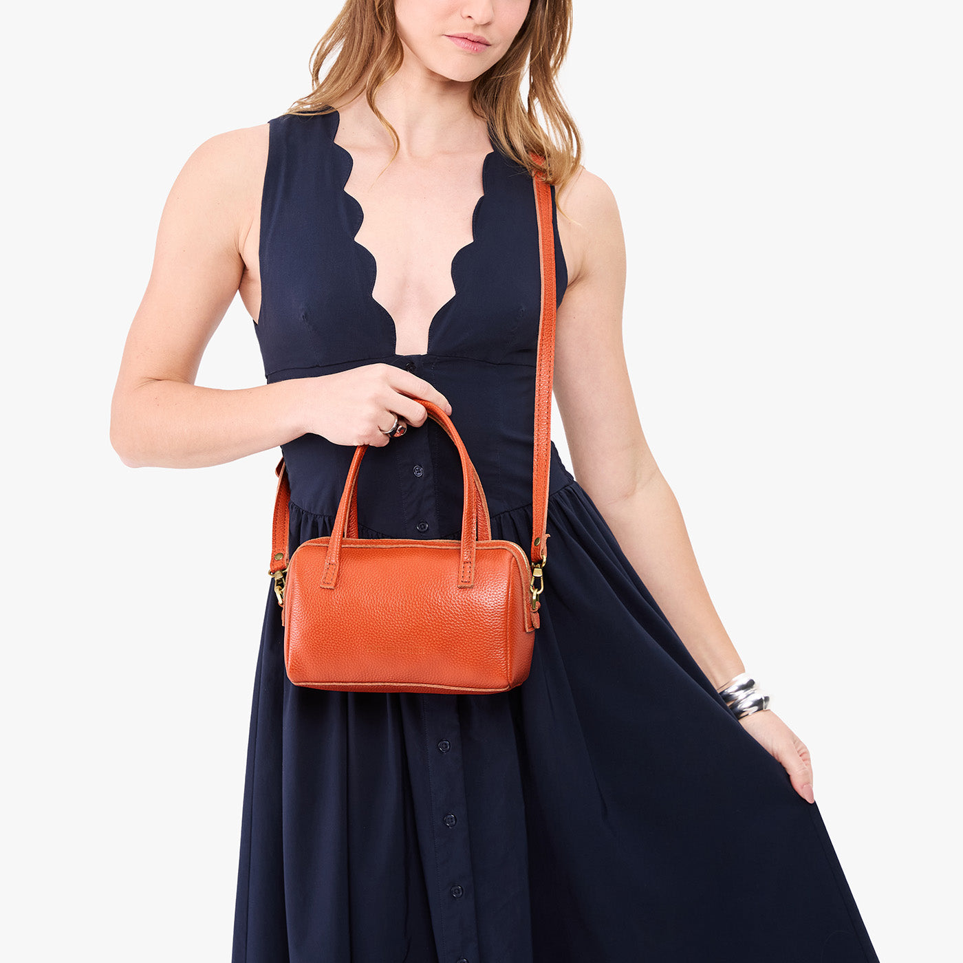 Koi*Small | Model holding mini duffle shaped handbag with crossbody strap