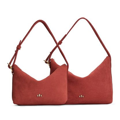 Cinnabar | Size comparison shot of small and large slouchy shoulder bags with zipper opening and three metal tree emblems