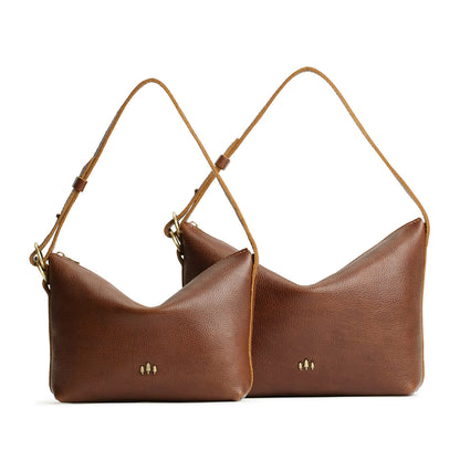 Asheville | Size comparison shot of small and large slouchy leather shoulder bags with zipper opening and three metal tree emblems