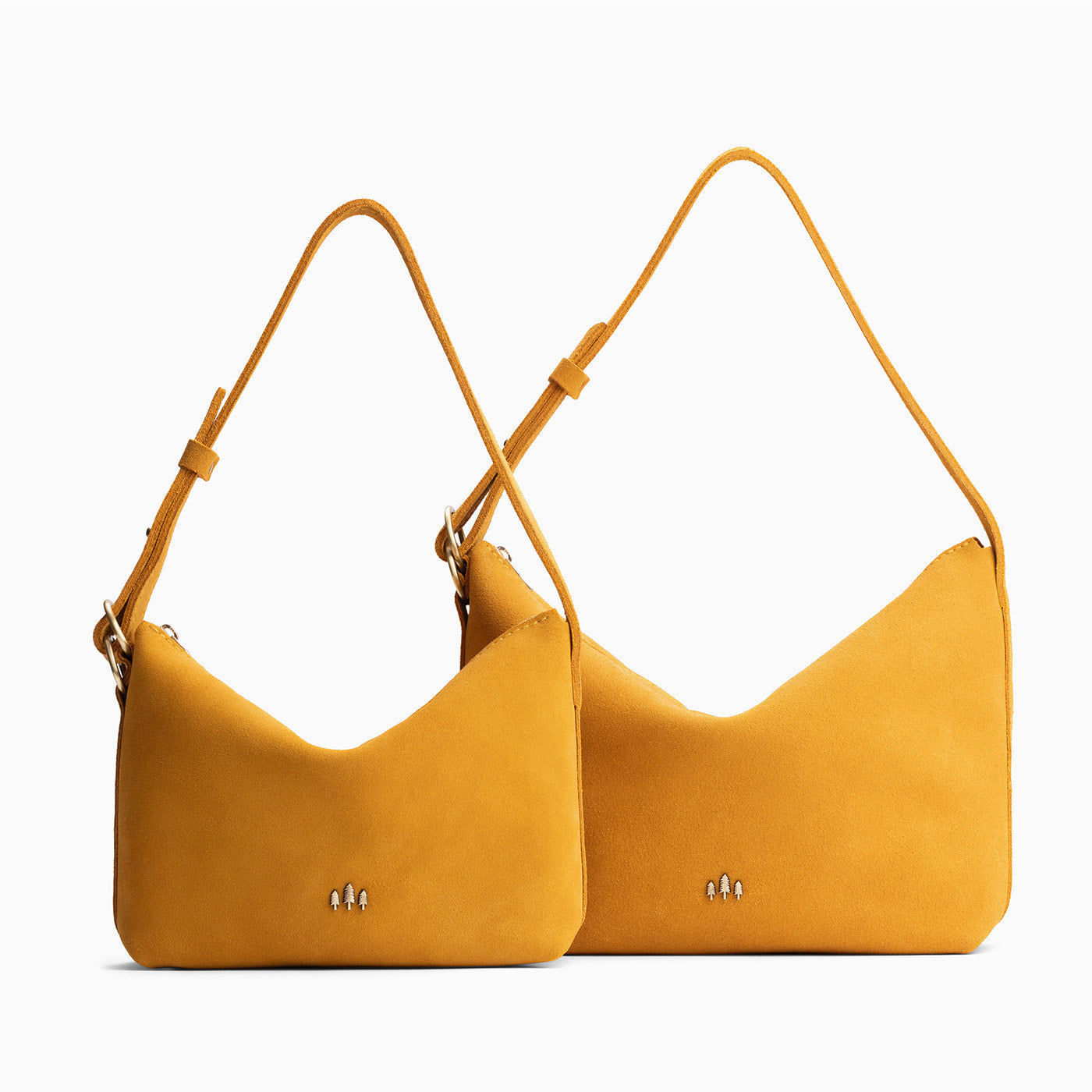 Dijon | Size comparison shot of small and large slouchy shoulder bags with zipper opening and three metal tree emblems