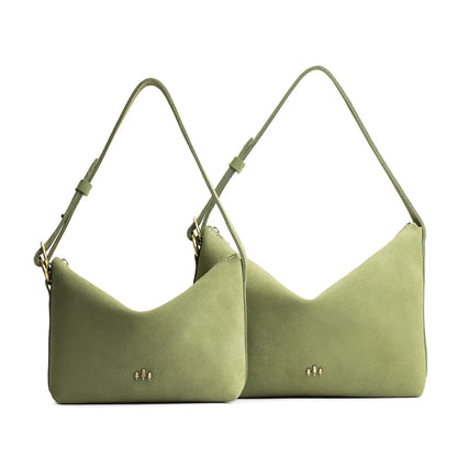 Laurel | Size comparison shot of small and large slouchy shoulder bags with zipper opening and three metal tree emblems