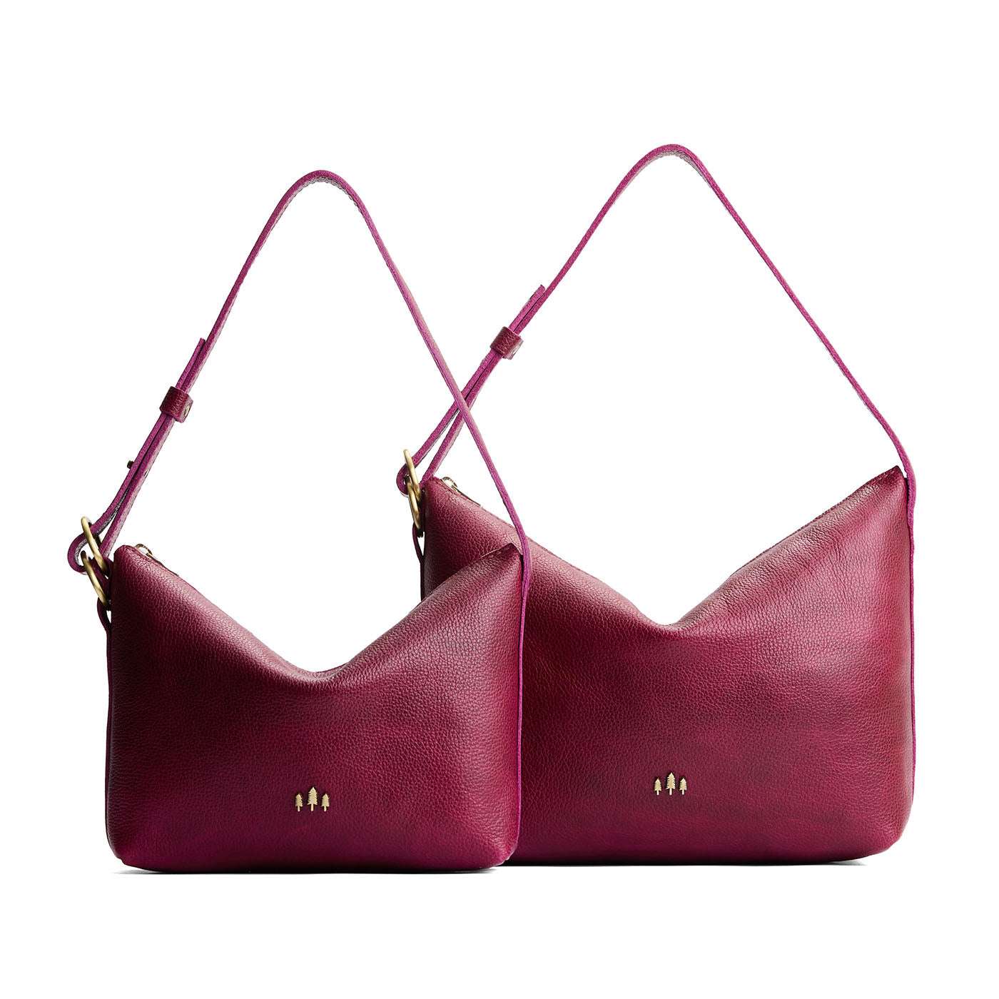 Orchid | Size comparison shot of small and large slouchy leather shoulder bags with zipper opening and three metal tree emblems