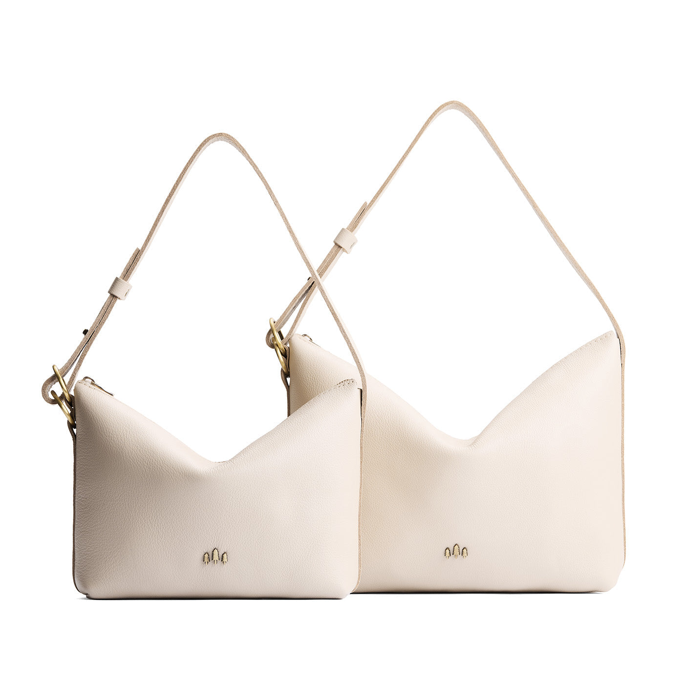 Pebbled Bone | Size comparison shot of small and large slouchy leather shoulder bags with zipper opening and three metal tree emblems