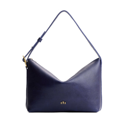Cobalt*Large | Model Wearing medium sized slouchy leather shoulder bag with zipper opening and three metal tree emblems