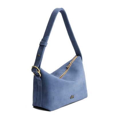 Denim*Small | Slouchy Shoulder Bag that has a zipper opening and three metal tree emblems on a white background