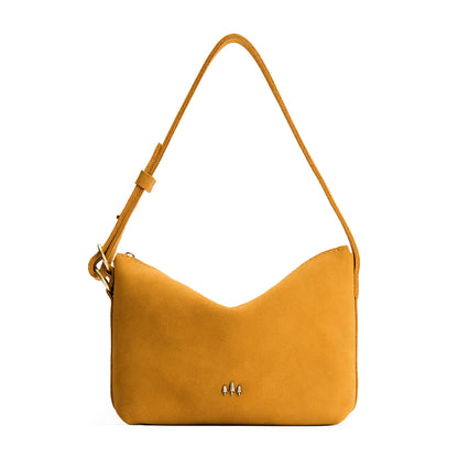 Dijon*Small | Slouchy Shoulder Bag that has a zipper opening and three metal tree emblems on a white background