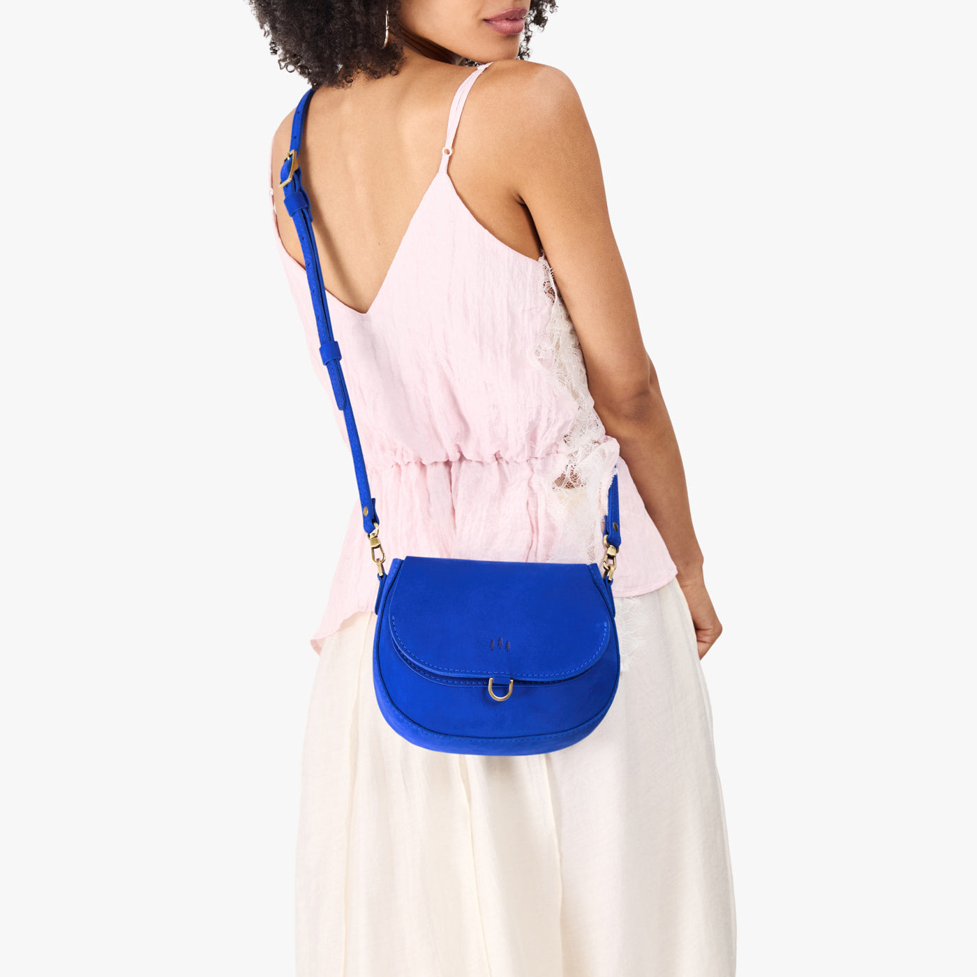 Blue Joy*Small | Model wearing a petite leather Crossbody with a flap and magnetic closure