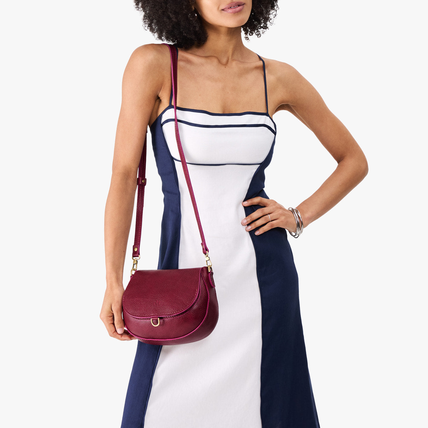 Orchid*Small | Model wearing a petite leather Crossbody with a flap and magnetic closure