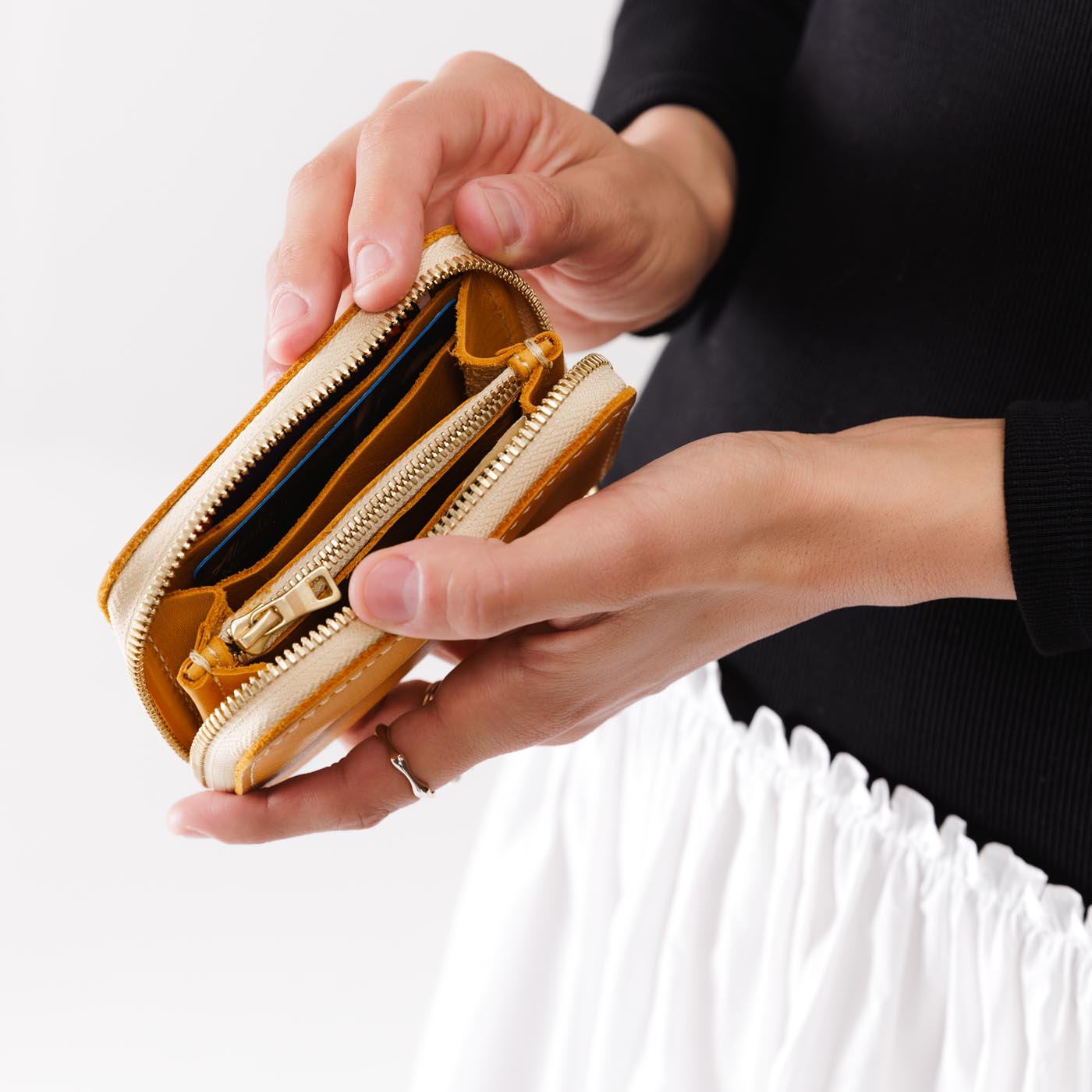 Sunflower | Model holding small leather wallet with zipper